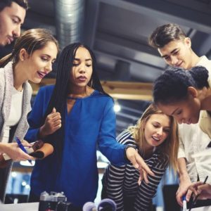 People in workplace around a table for Enovation